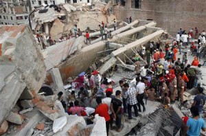 Rescue workers try to rescue trapped garment workers in the Rana Plaza building which collapsed, in Savar